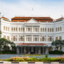 Grand white front of hotel with copper roof tiles