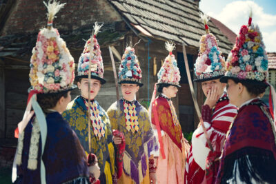 Young women prepare for the spring procession of queens in the village of Gorjani on Pentecost Sunday