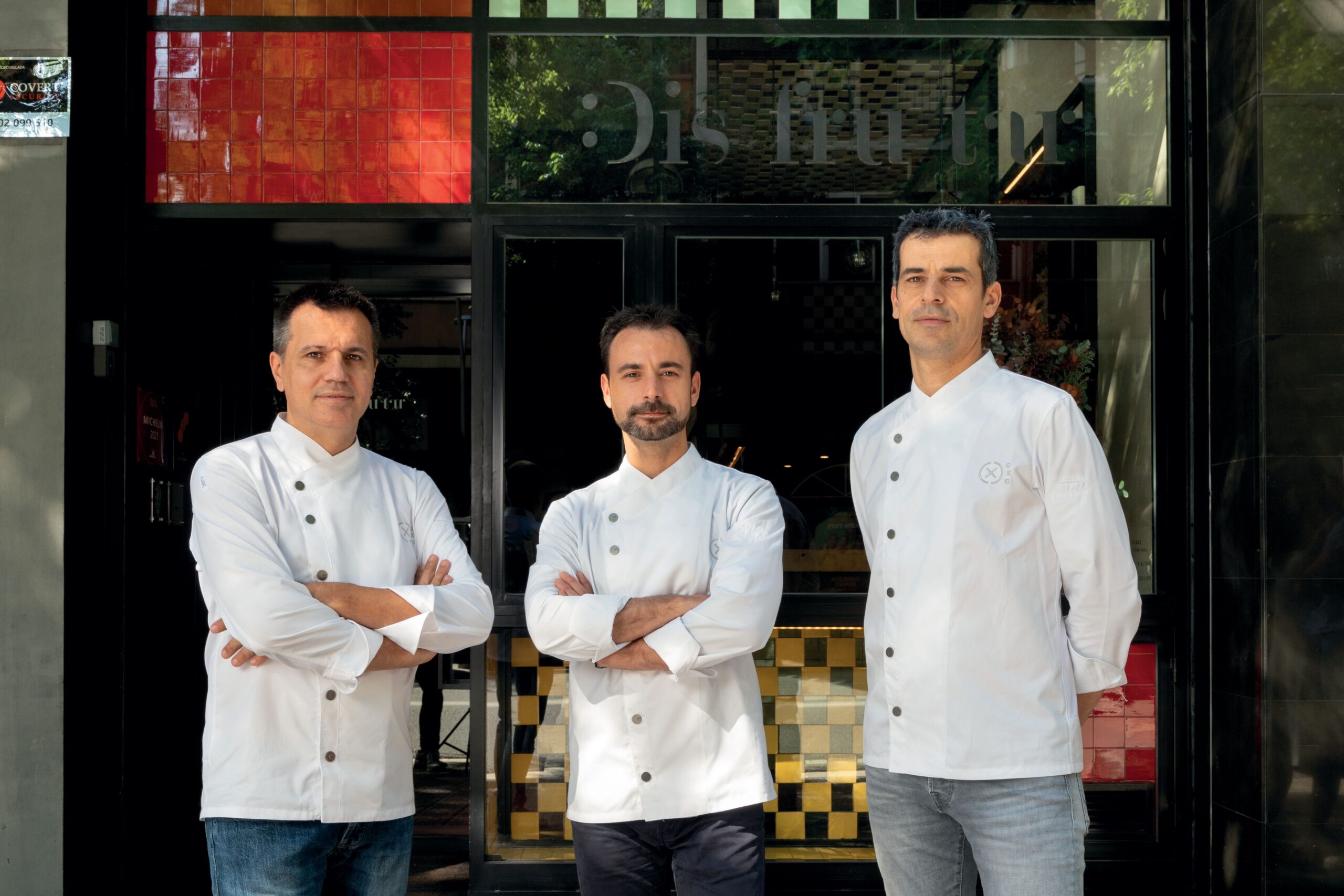 3 chiefs standing outside of the restaurant