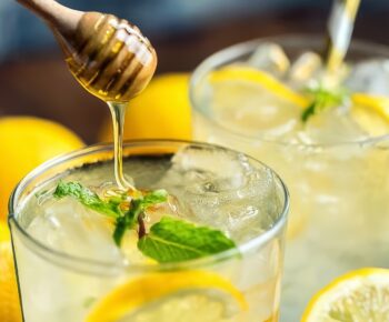 Picture of honey being added to the Kenyan cocktail dawa