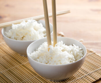 Chopsticks sticking out of a bowl of rice vertically