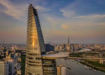 Aerial panoramic cityscape view of Ho Chi Minh City as taken from next to the Bitexco tower which is in the foreground