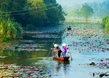 Traditional boats on yen stream on the way to Huong pagoda