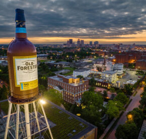 The Brown-Forman tower stands in front of the Louisville skyline at dusk