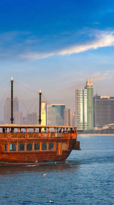 Traditional dhow boat with the Abu Dhabi skyline in the background