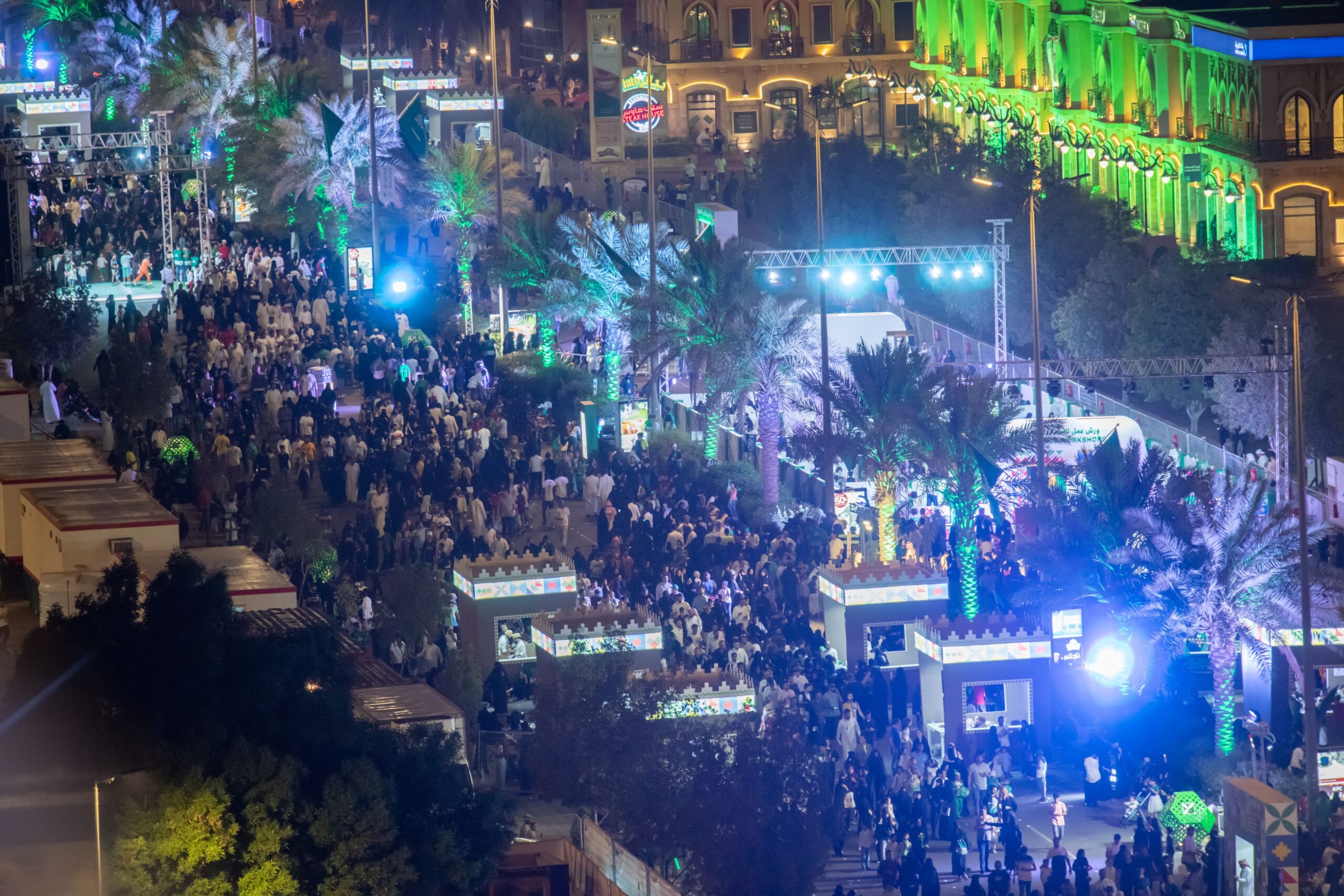 Love market at night, there are crowds of people walking in the lit up streets