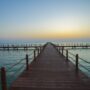 Wooden bridge pier leading to the sea