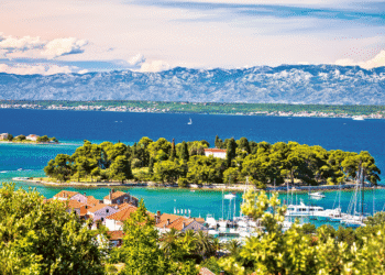 The waterfront in the town of Preko on Ugljan Island in the Zadar Archipelago, with a view of the little island of Galovac