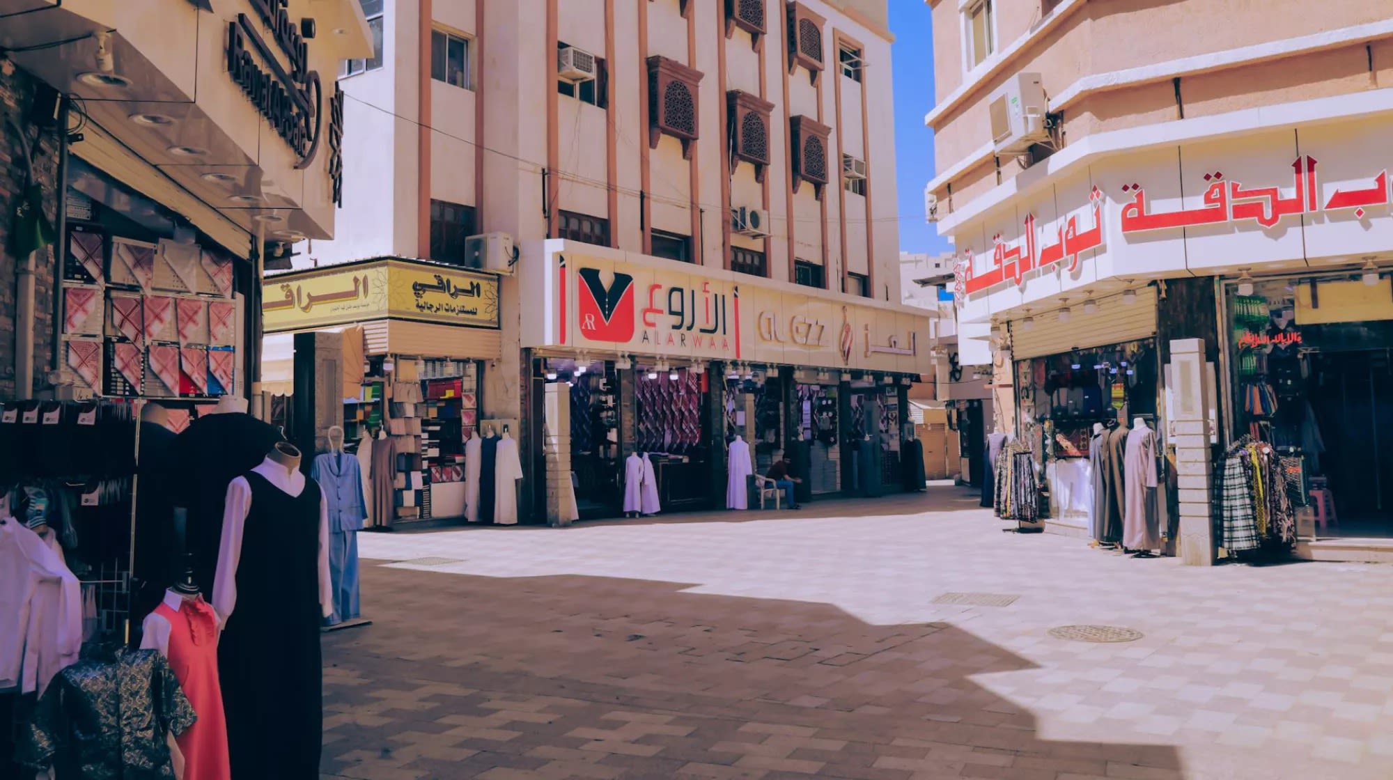 A street with stores selling clothes
