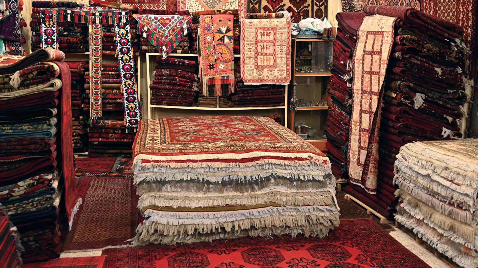 A store selling a range of carpets, they are very colourful and come with a range of sizes