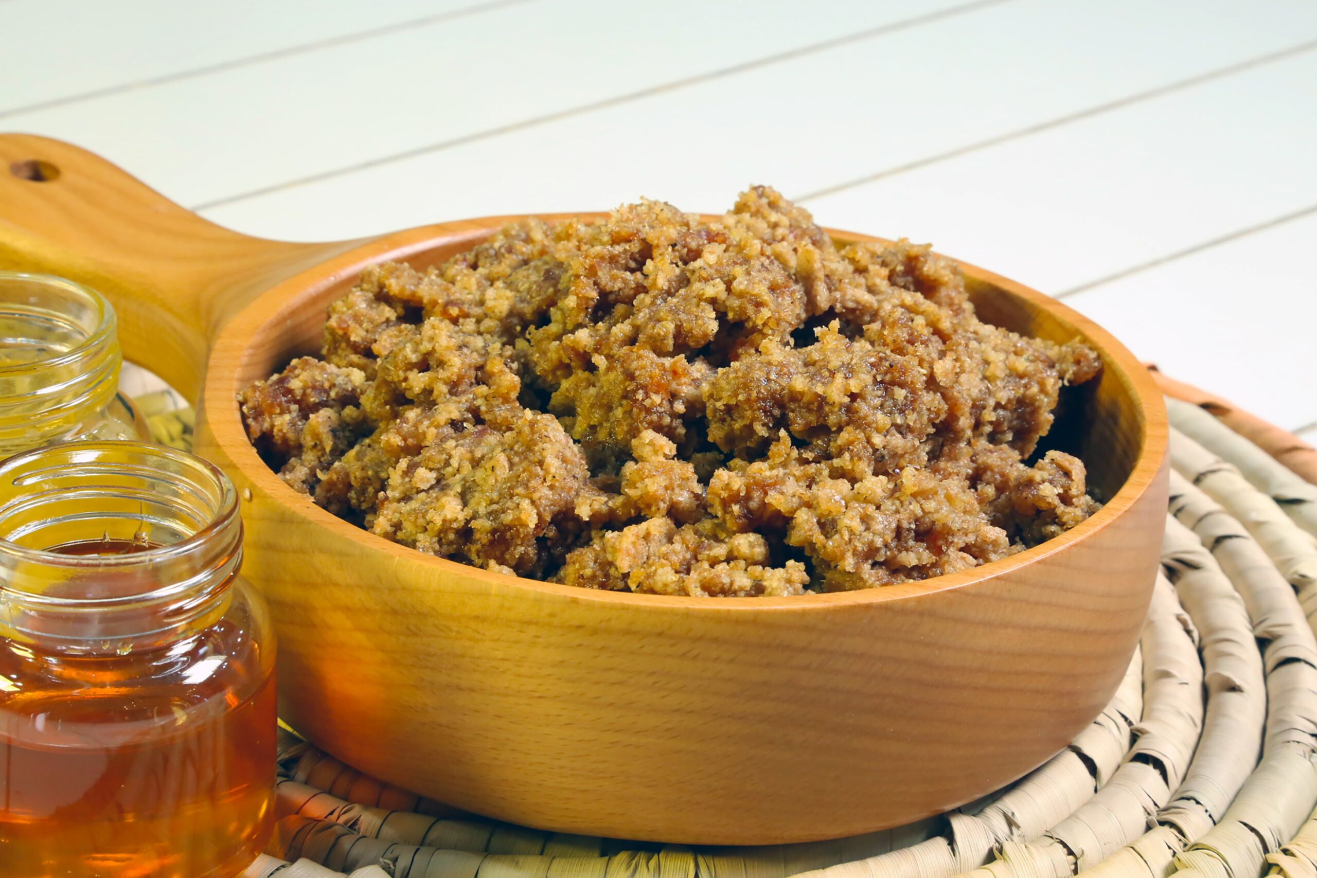 A traditional hanini sees dates, brown flour and spices including cardamom and saffron all come in a wooden bowl