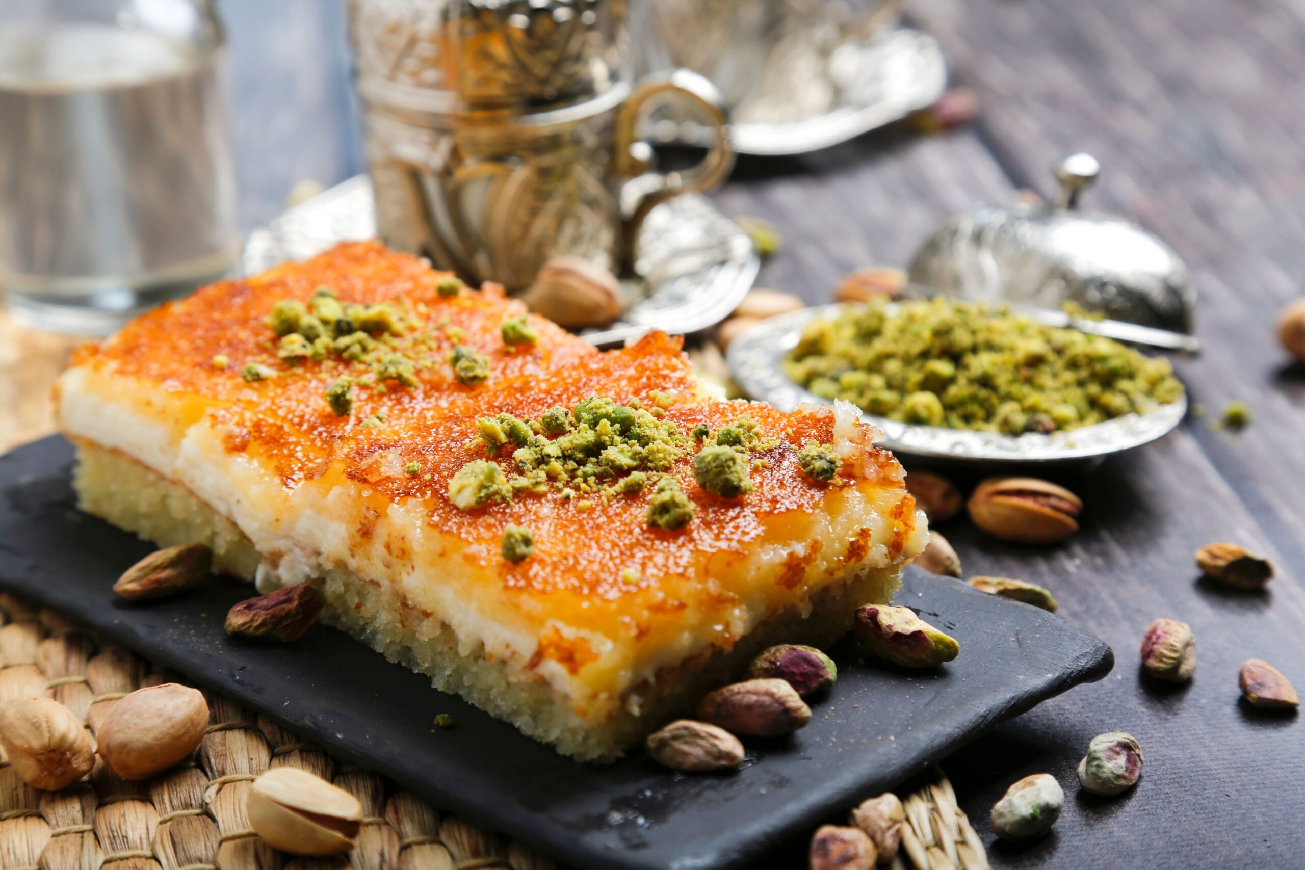 Dessert made of semolina and sugar cut into squares with pistachio on top