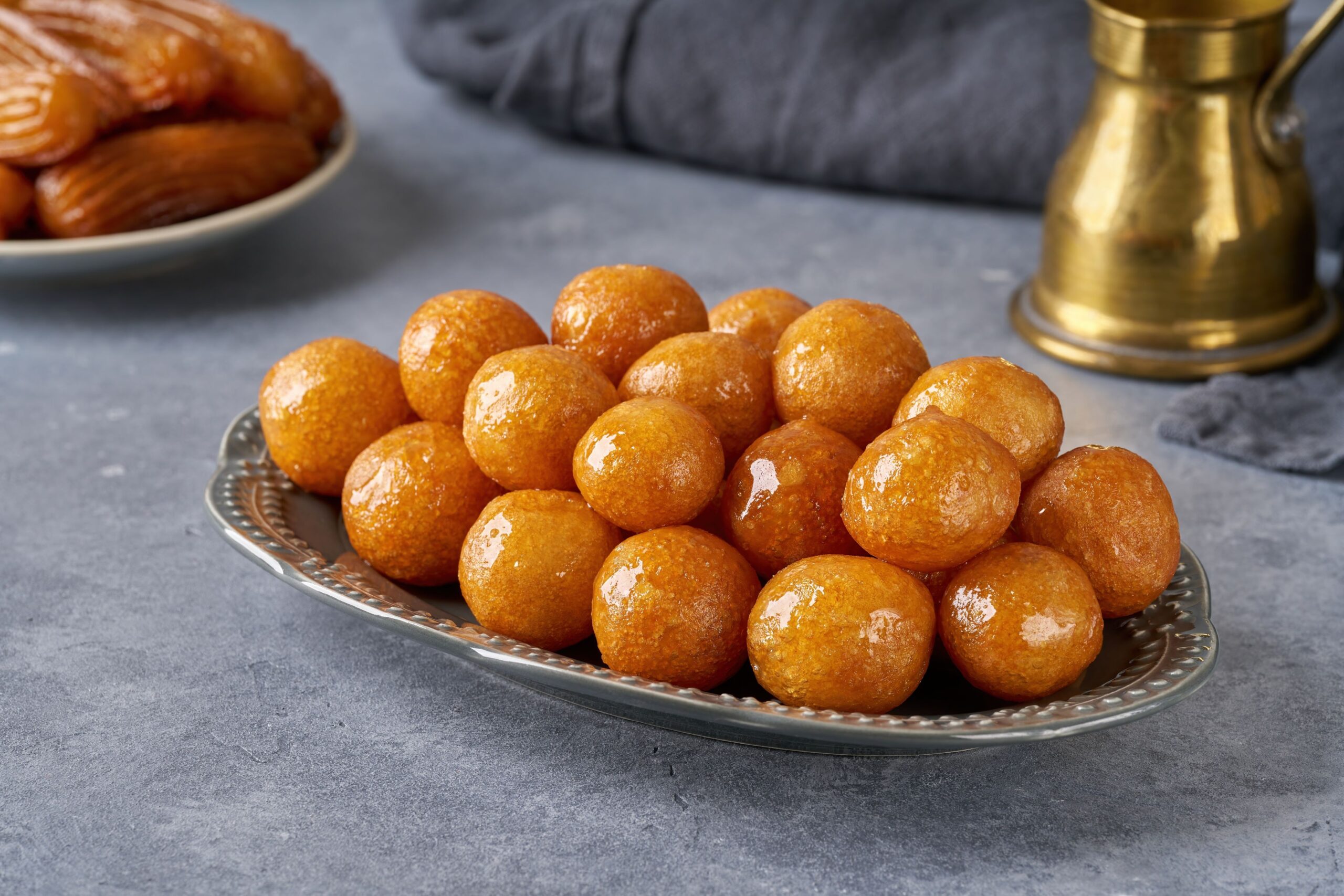 An Emirati delicacy. Small round Arabic doughnuts on a metal plate