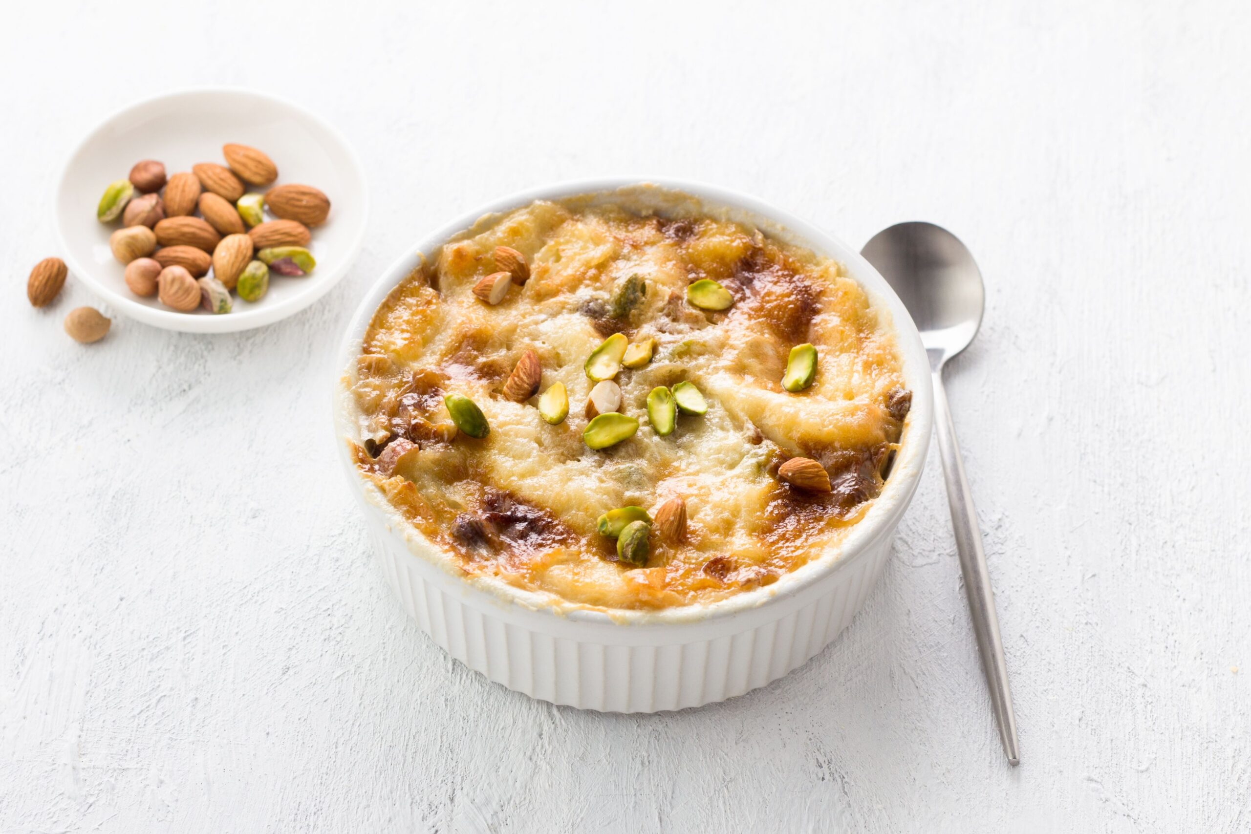 A desert in a bowl, with crust and nuts on top