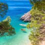 Idyllic beach Punta Rata in Brela view through Mediterranean trees, Makarska riviera of Dalmatia, Croatia