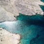 Pag Island coastline with a boat in the cove near Jadra Beach, Stara Novalja and Zigljen, Croatia and the beautiful blue Adriatic sea