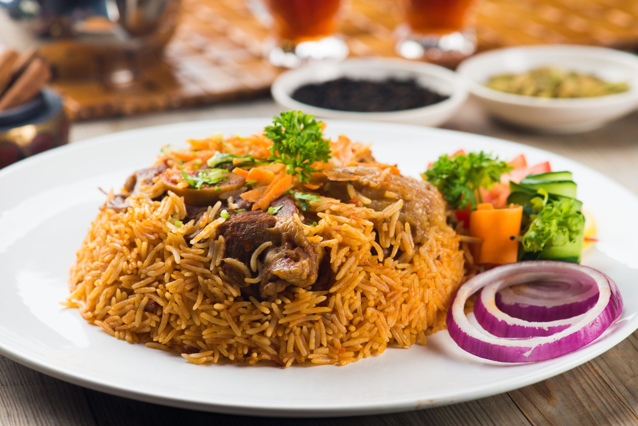 Rice and meat cooked in a pressure cooker served on a plate with vegetables