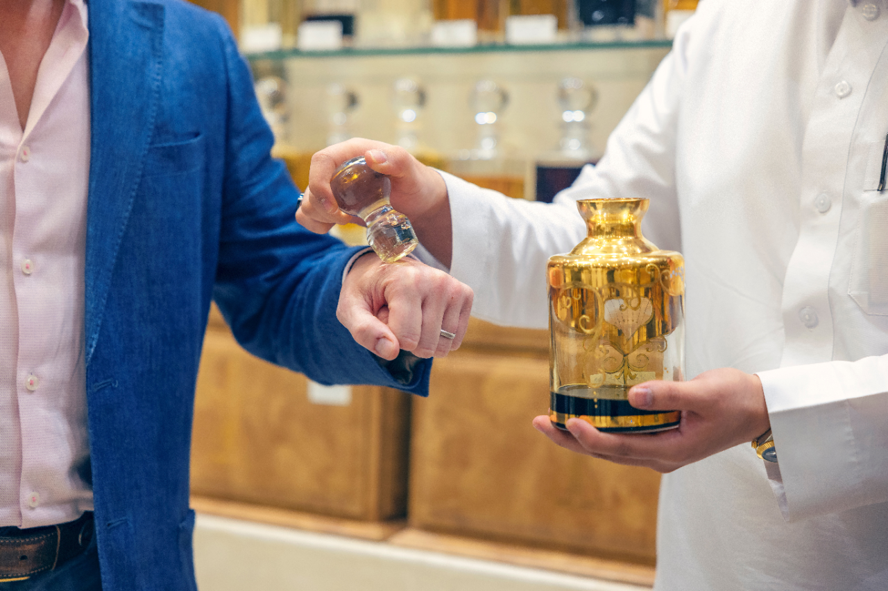 Perfume being placed on the hand of a man