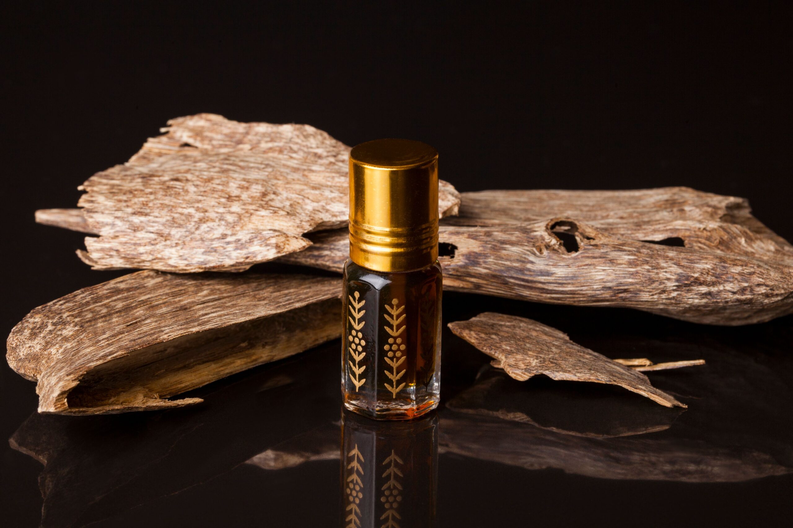 Scented oil in a glass bottle with gold detail