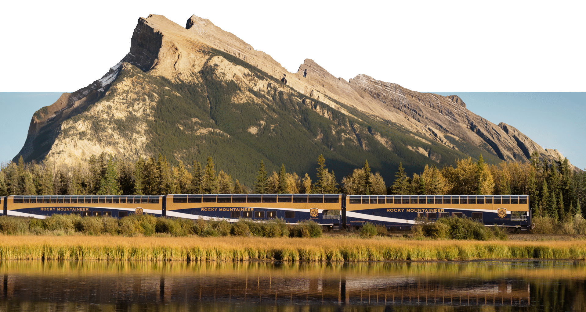 Rocky Mountaineer in motion with mountain backdrop