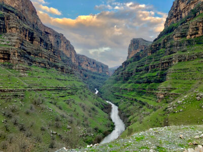 River flowing through mountains either side