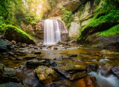 Waterfall with tranquil river in foreground