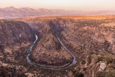 A winding road carving through red canyon rock