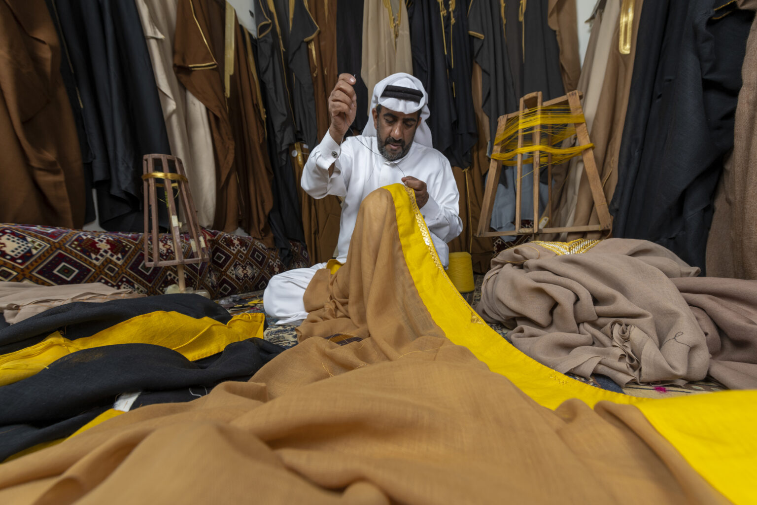 Man sewing fabric in Saudi Arabia Souq